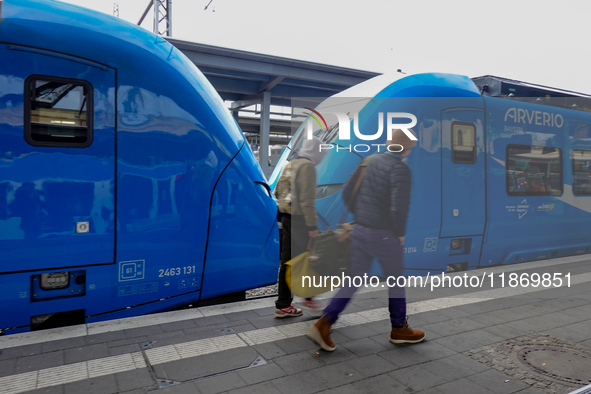 An Arverio train is stationed at Augsburg Central Station in Augsburg, Bavaria, Germany, on December 14, 2024, showcasing the vibrant blue d...