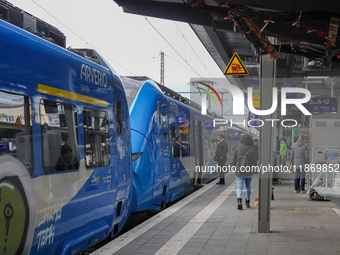 At Platform 5 of Augsburg Central Station in Bavaria, Germany, on December 14, 2024, a train attendant ensures smooth boarding for passenger...