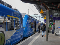 At Platform 5 of Augsburg Central Station in Bavaria, Germany, on December 14, 2024, a train attendant ensures smooth boarding for passenger...