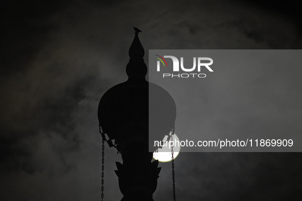 The final full moon, or cold moon, rises behind the minaret of a mosque in Srinagar, Kashmir, India, on December 14, 2024. In India, reports...