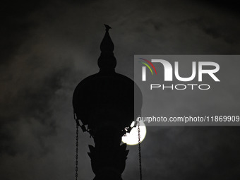 The final full moon, or cold moon, rises behind the minaret of a mosque in Srinagar, Kashmir, India, on December 14, 2024. In India, reports...