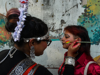 A participant paints pride flags on the cheeks of others during the annual pride walk in Kolkata, India, on December 15, 2024. (