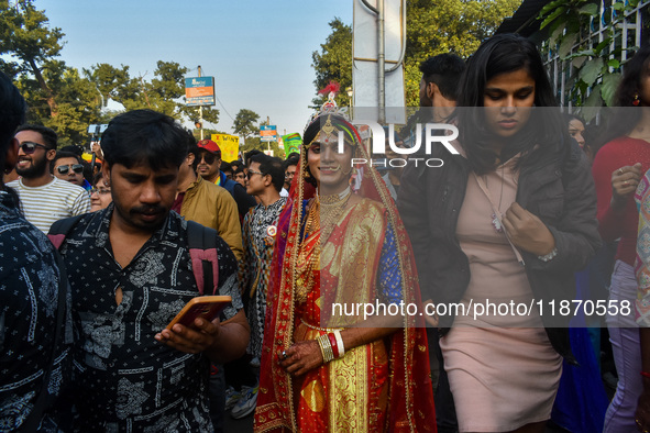 A trans man is seen dressed in traditional Bengali wedding attire during the annual pride walk in Kolkata, India, on December 15, 2024. 