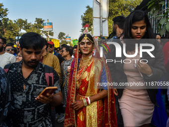 A trans man is seen dressed in traditional Bengali wedding attire during the annual pride walk in Kolkata, India, on December 15, 2024. (