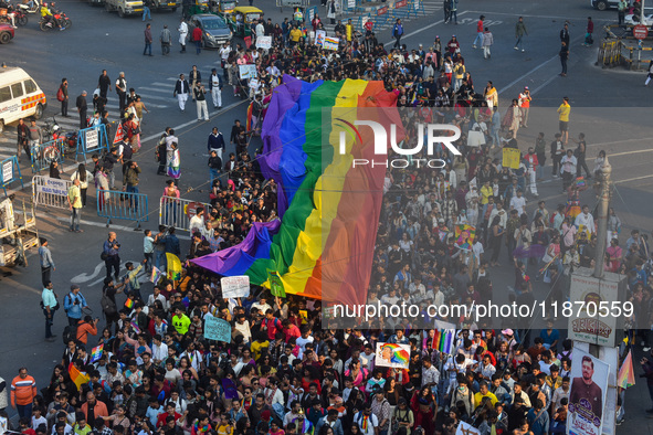 A giant pride flag is seen during the annual Pride walk in Kolkata, India, on December 15, 2024. 