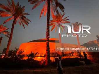 A worker walks past a building after sunset in Riyadh, Saudi Arabia on 03 March, 2024. (