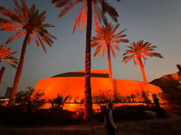 A worker walks past a building after sunset in Riyadh, Saudi Arabia on 03 March, 2024. (