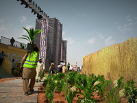 A migrant worker carries a potted Fiji Fan Palm at a construction site near Riyadh, Saudi Arabia on 03 March, 2024. (