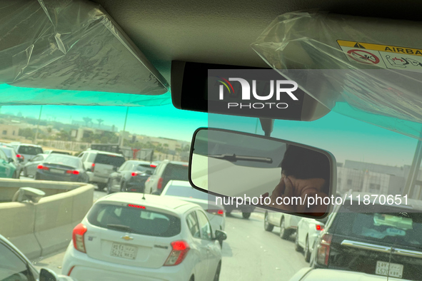 A driver rubs his eyes while in traffic near Riyadh, Saudi Arabia on 03 March, 2024. 