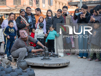 The crowd watches a man demonstrate pottery-making at Bhaktapur Durbar Square during the Bhaktapur Mahotsav (Bhaktapur Street Festival) on S...