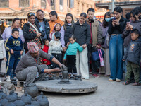 The crowd watches a man demonstrate pottery-making at Bhaktapur Durbar Square during the Bhaktapur Mahotsav (Bhaktapur Street Festival) on S...