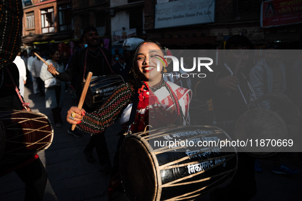 A young woman dressed in traditional Newari attire plays the dhime drum in Bhaktapur, Nepal, on Sunday. 