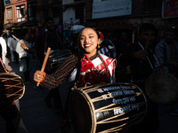 A young woman dressed in traditional Newari attire plays the dhime drum in Bhaktapur, Nepal, on Sunday. (