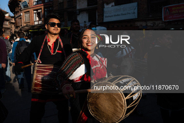 A young woman dressed in traditional Newari attire plays the dhime drum in Bhaktapur, Nepal, on Sunday. 