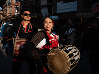 A young woman dressed in traditional Newari attire plays the dhime drum in Bhaktapur, Nepal, on Sunday. (