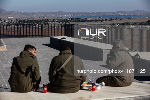 Israeli soldiers and Israeli civilians visit a lookout point next to the boundary fence delineating the UN-patrolled buffer zone between Isr...