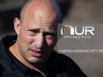 Former Israeli Prime Minister Naftali Bennett visits a lookout point next to the boundary fence delineating the UN-patrolled buffer zone bet...