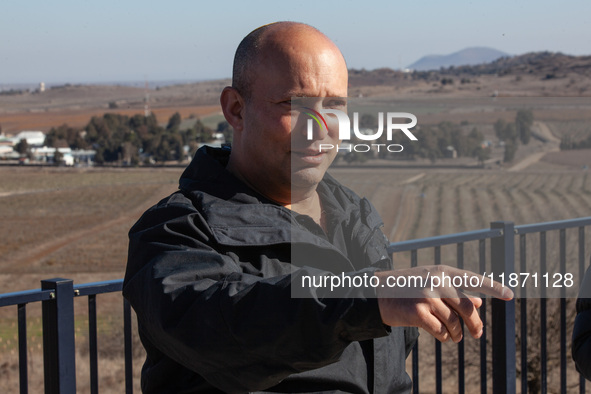 Former Israeli Prime Minister Naftali Bennett visits a lookout point next to the boundary fence delineating the UN-patrolled buffer zone bet...