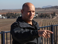 Former Israeli Prime Minister Naftali Bennett visits a lookout point next to the boundary fence delineating the UN-patrolled buffer zone bet...