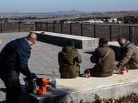 Israeli soldiers and civilians visit a lookout point next to the boundary fence delineating the UN-patrolled buffer zone between Israel and...