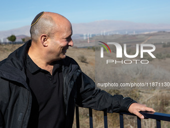 Former Israeli Prime Minister Naftali Bennett visits a lookout point next to the boundary fence delineating the UN-patrolled buffer zone bet...