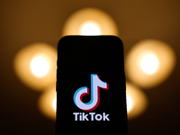 TikTok logo displayed on a phone screen is seen in this illustration photo taken in Poland on December 15, 2024. (