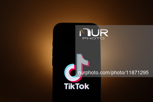 TikTok logo displayed on a phone screen is seen in this illustration photo taken in Poland on December 15, 2024. 