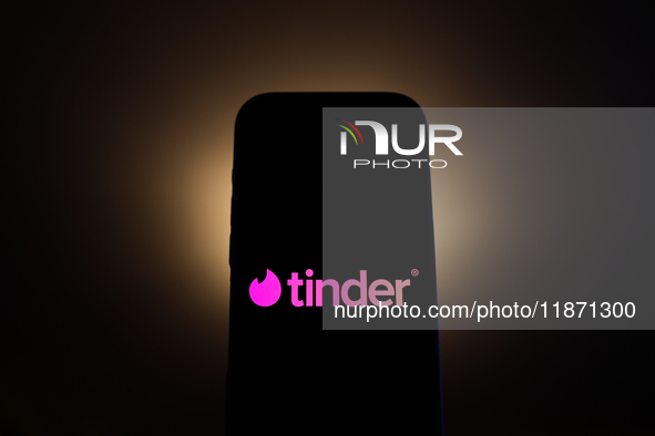 Tinder logo displayed on a phone screen is seen in this illustration photo taken in Poland on December 15, 2024. 