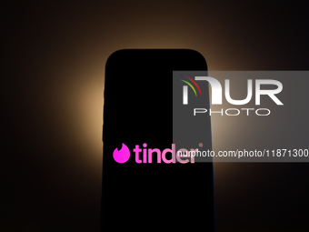 Tinder logo displayed on a phone screen is seen in this illustration photo taken in Poland on December 15, 2024. (