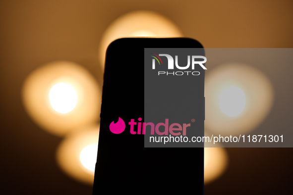 Tinder logo displayed on a phone screen is seen in this illustration photo taken in Poland on December 15, 2024. 