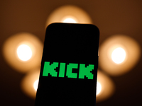 Kick logo displayed on a phone screen is seen in this illustration photo taken in Poland on December 15, 2024. (