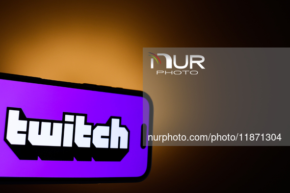 Twitch logo displayed on a phone screen is seen in this illustration photo taken in Poland on December 15, 2024. 