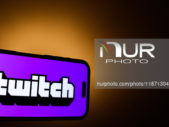 Twitch logo displayed on a phone screen is seen in this illustration photo taken in Poland on December 15, 2024. (