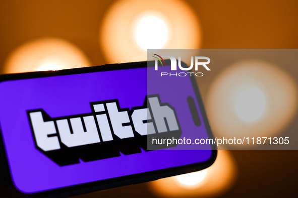 Twitch logo displayed on a phone screen is seen in this illustration photo taken in Poland on December 15, 2024. 