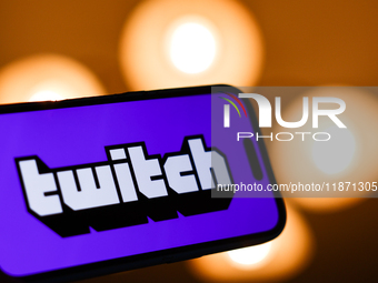 Twitch logo displayed on a phone screen is seen in this illustration photo taken in Poland on December 15, 2024. (