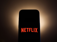 Netflix logo displayed on a phone screen is seen in this illustration photo taken in Poland on December 15, 2024. (