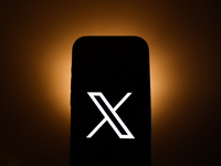 X logo displayed on a phone screen is seen in this illustration photo taken in Poland on December 15, 2024. (