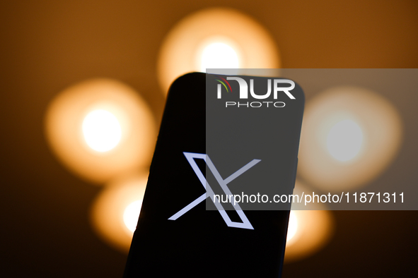 X logo displayed on a phone screen is seen in this illustration photo taken in Poland on December 15, 2024. 