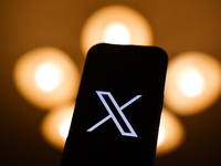 X logo displayed on a phone screen is seen in this illustration photo taken in Poland on December 15, 2024. (