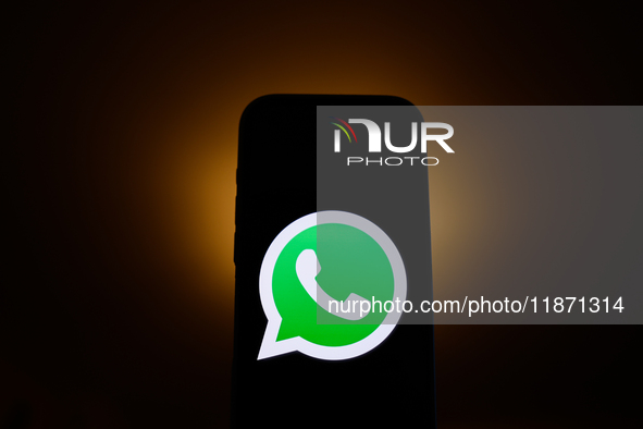 WhatsApp logo displayed on a phone screen is seen in this illustration photo taken in Poland on December 15, 2024. 