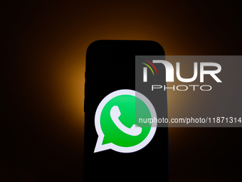 WhatsApp logo displayed on a phone screen is seen in this illustration photo taken in Poland on December 15, 2024. (