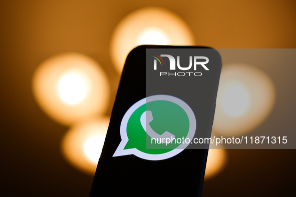 WhatsApp logo displayed on a phone screen is seen in this illustration photo taken in Poland on December 15, 2024. 