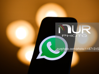 WhatsApp logo displayed on a phone screen is seen in this illustration photo taken in Poland on December 15, 2024. (