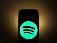 Spotify logo displayed on a phone screen is seen in this illustration photo taken in Poland on December 15, 2024. (