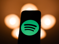 Spotify logo displayed on a phone screen is seen in this illustration photo taken in Poland on December 15, 2024. (