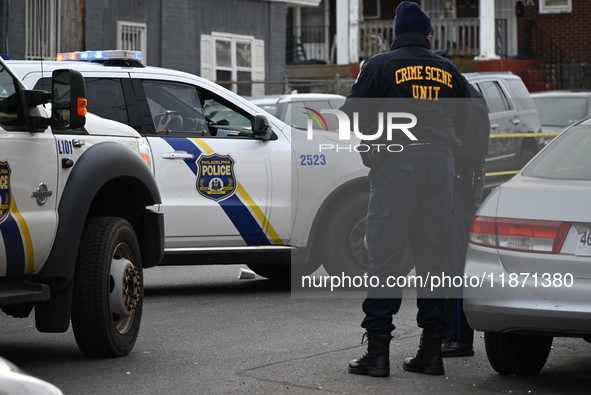 Philadelphia Police crime scene unit investigators are at the scene where one person is killed and four other people are injured in a mass s...