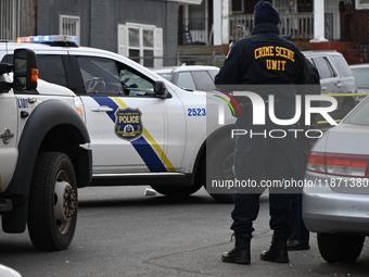 Philadelphia Police crime scene unit investigators are at the scene where one person is killed and four other people are injured in a mass s...