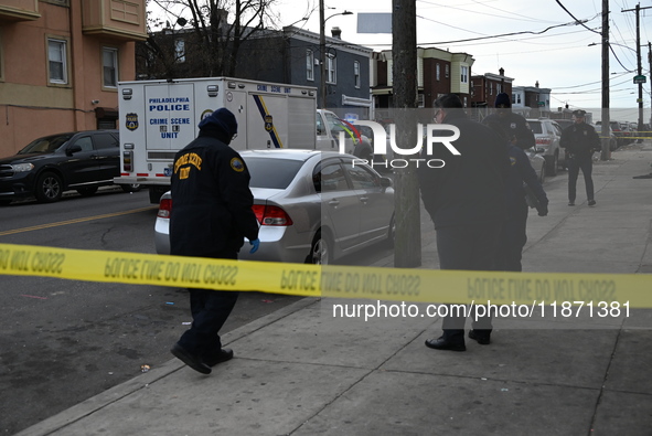 Philadelphia Police crime scene unit investigators are at the scene where one person is killed and four other people are injured in a mass s...