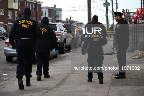 Philadelphia Police crime scene unit investigators are at the scene where one person is killed and four other people are injured in a mass s...