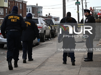 Philadelphia Police crime scene unit investigators are at the scene where one person is killed and four other people are injured in a mass s...